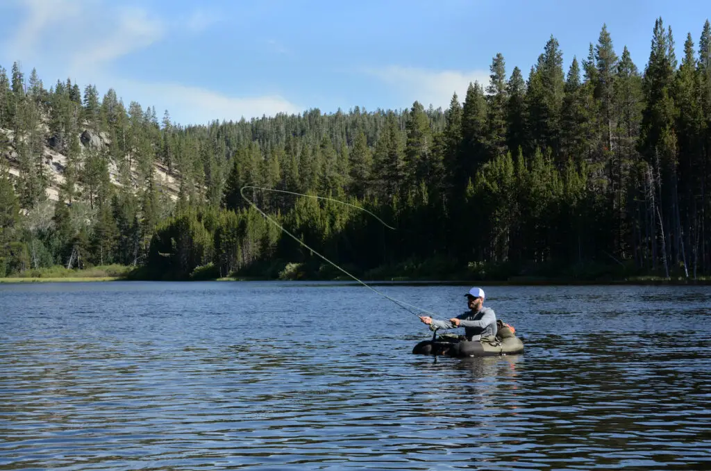 A fly fisherman casting from a fishing float tube